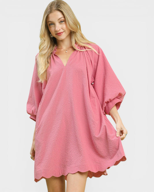 Woman wearing a pink dress on a white background