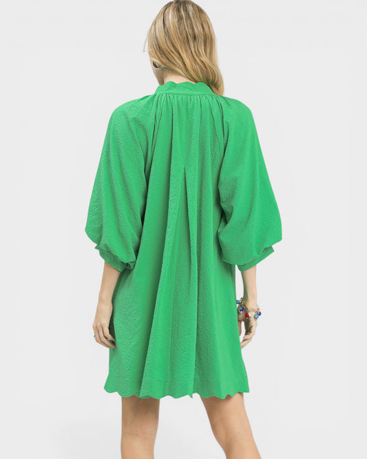 Green dress worn by a person on a white background