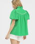 Woman wearing a green blouse with white trim on a white background