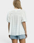 Person wearing a light-colored textured blouse and denim shorts on a white background