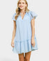 Woman wearing a light blue striped dress on a white background