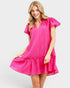 Woman wearing a bright pink dress on a white background