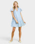 Woman wearing a light blue dress on a white background