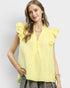 Woman wearing a yellow sleeveless top with ruffled shoulders on a light gray background