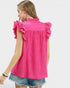 Woman wearing a bright pink sleeveless top with ruffled details on a white background