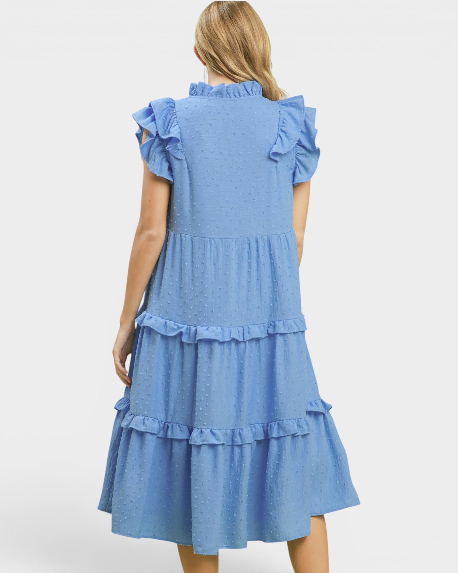 Blue dress with ruffled details on a white background