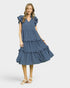 Woman wearing a blue tiered dress on a white background