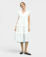 Woman wearing a white dress on a plain background