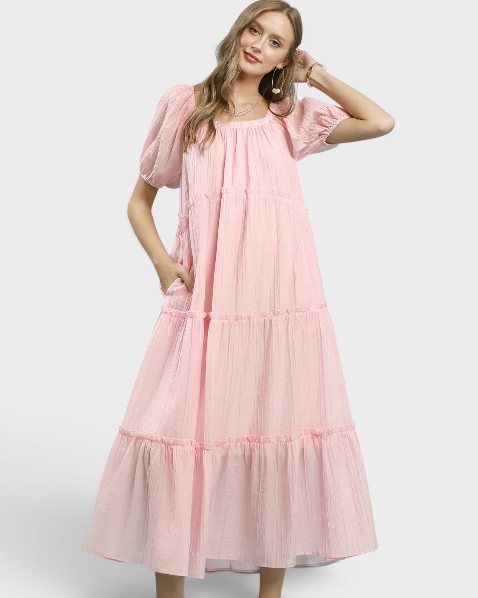 Woman wearing a pink dress on a white background