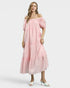 Woman wearing a pink off-shoulder dress on a white background
