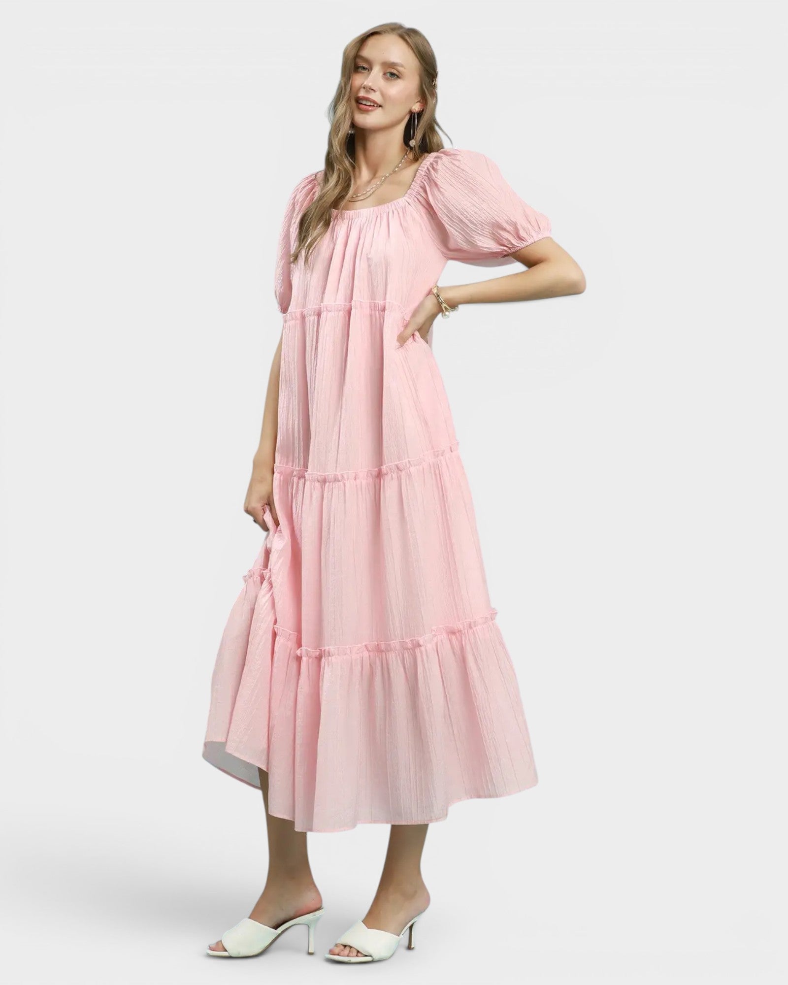Woman wearing a pink dress on a white background