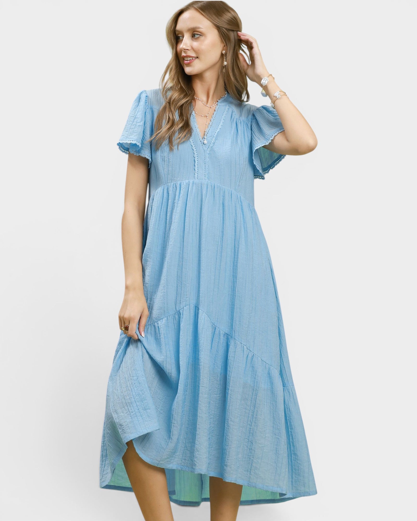 Woman wearing a blue dress on a white background