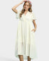 Woman wearing a cream dress on a white background
