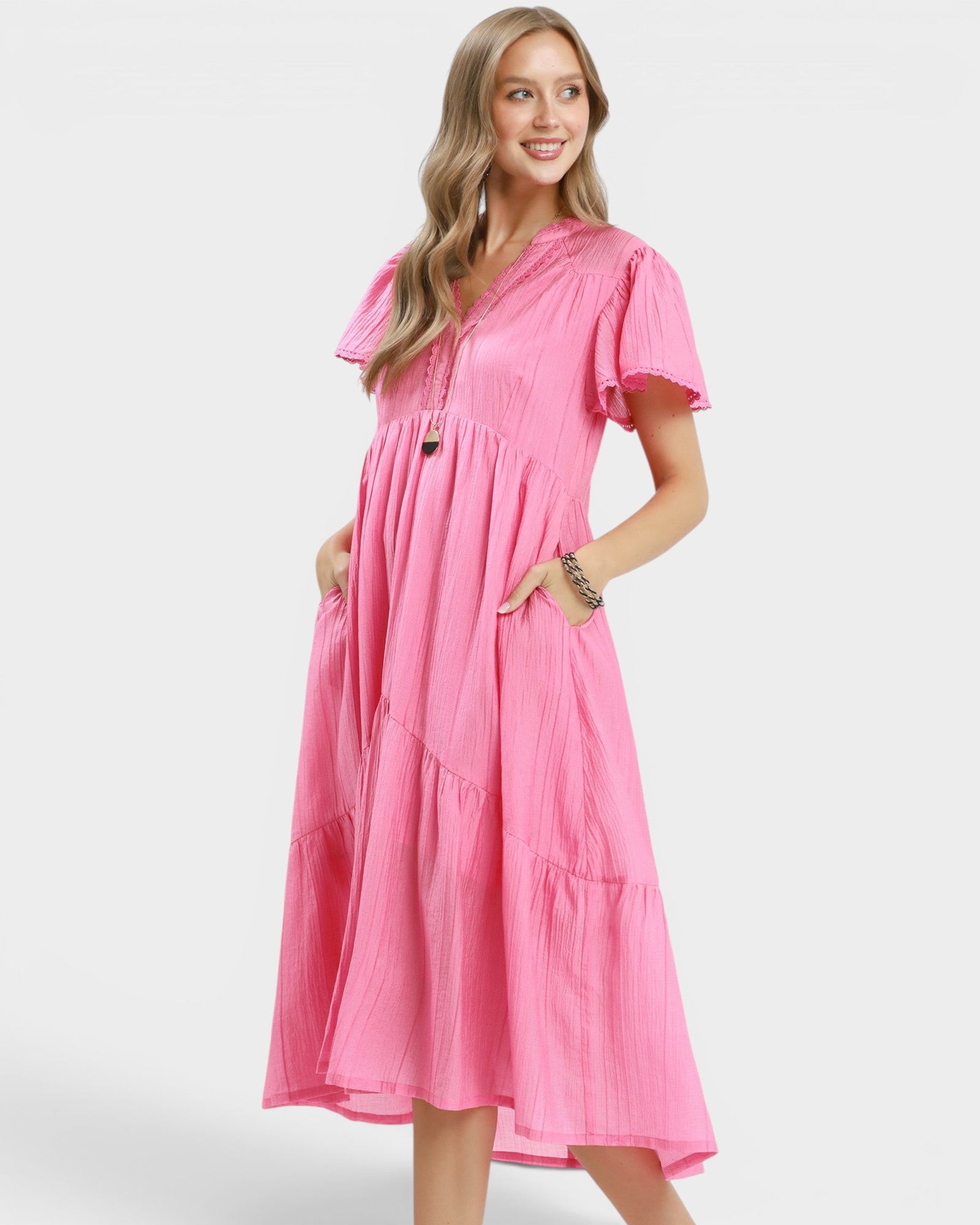 Woman wearing a pink dress on a white background