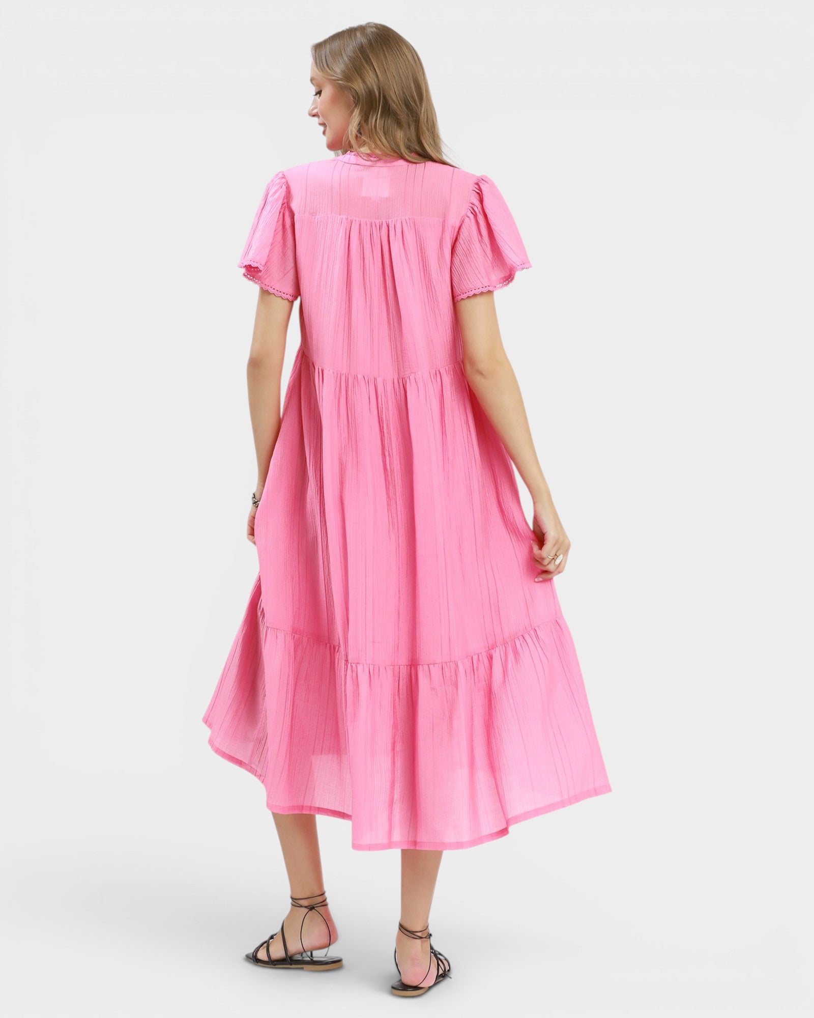 Woman wearing a pink dress on a white background