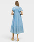 Woman wearing a light blue dress on a white background
