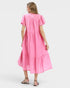 Woman wearing a pink dress on a white background