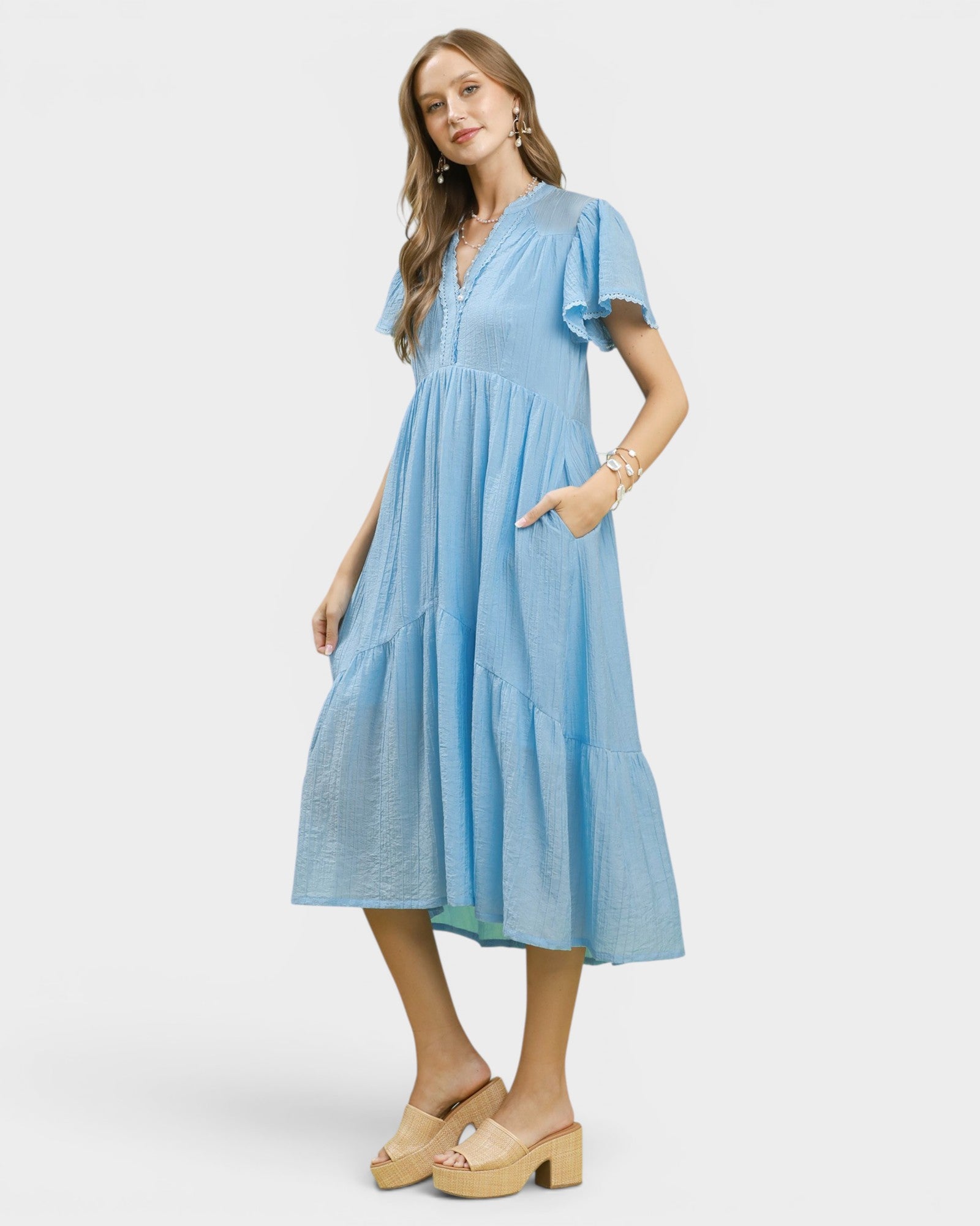 Woman wearing a blue dress on a white background