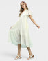 Woman wearing a cream dress on a white background