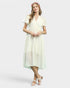 Woman wearing a cream dress on a white background