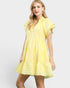 Woman wearing a yellow dress on a white background