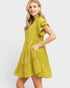 Woman wearing a yellow tiered dress on a white background