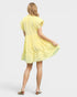 Woman wearing a yellow dress on a plain background
