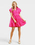 Woman wearing a bright pink dress on a white background