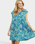 Woman wearing a blue floral dress on a white background