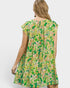 Woman wearing a green floral dress on a white background