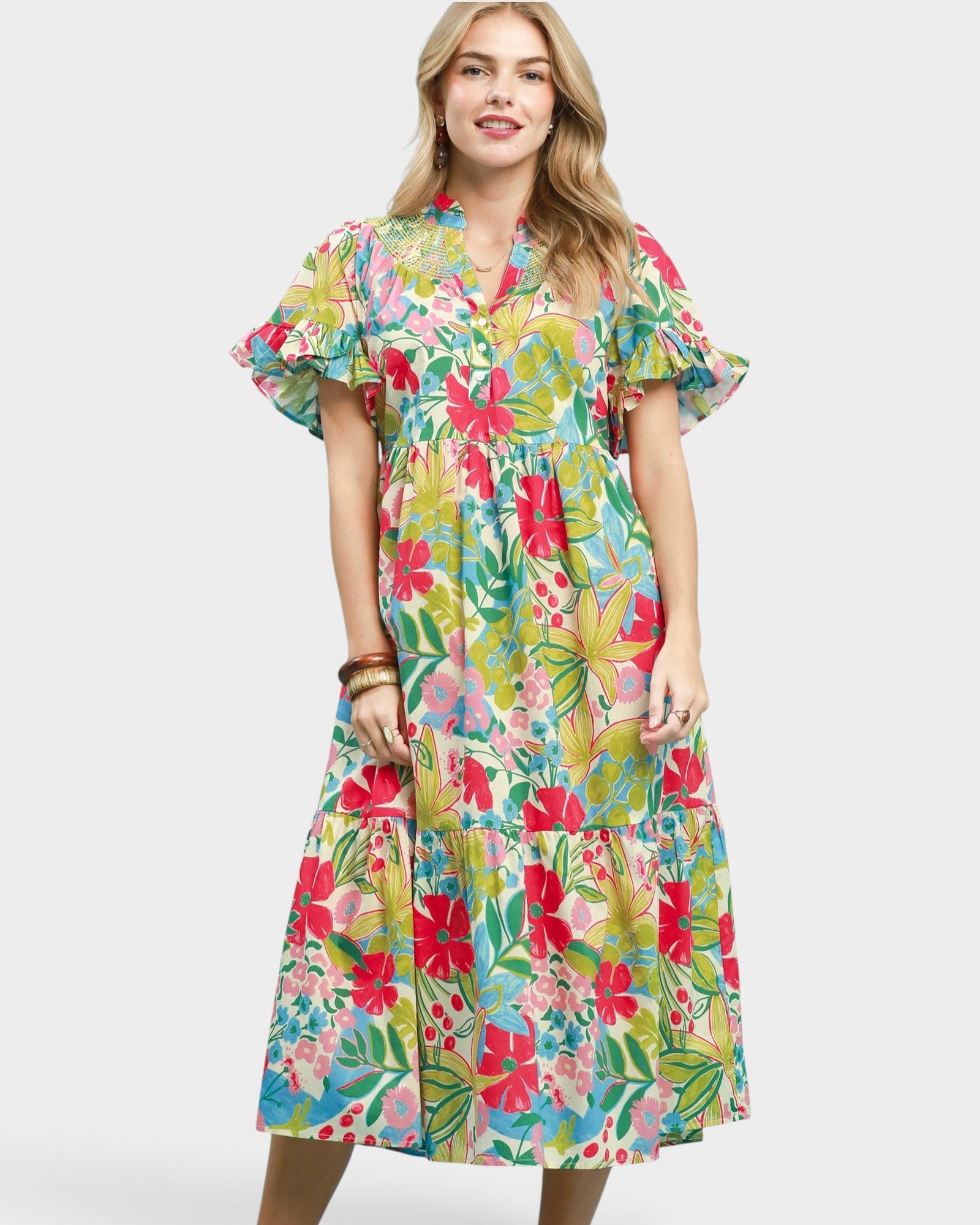 Woman wearing a colorful floral dress on a white background
