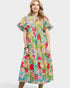 Woman wearing a colorful floral dress on a white background