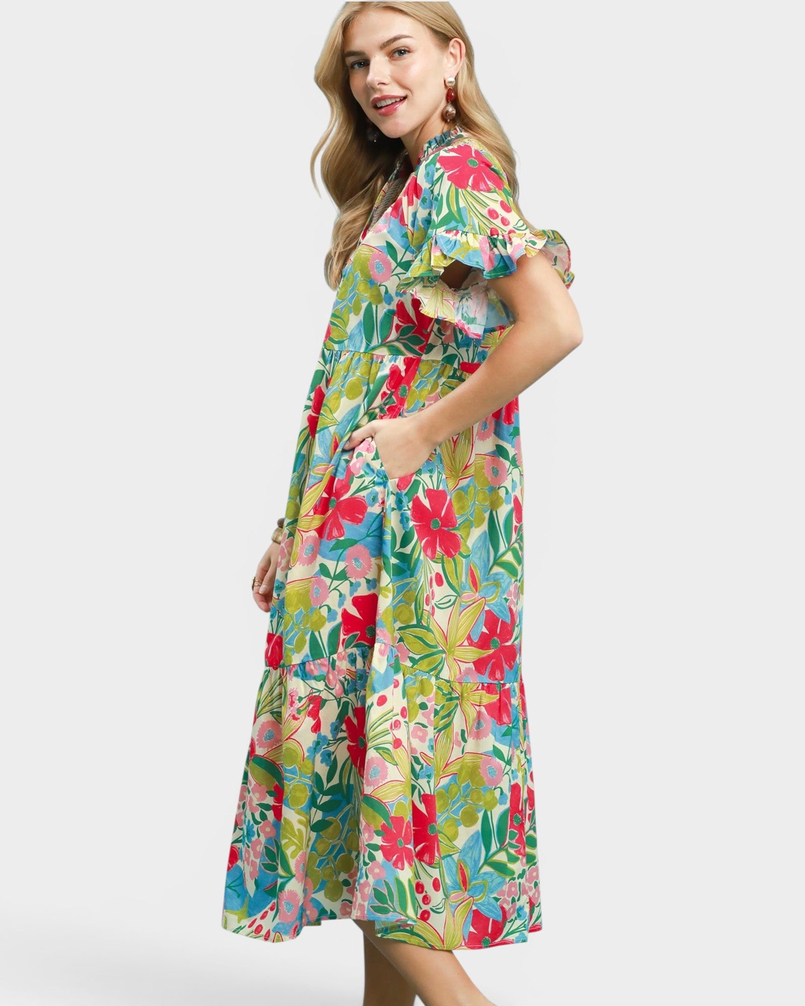 Woman wearing a colorful floral dress on a white background