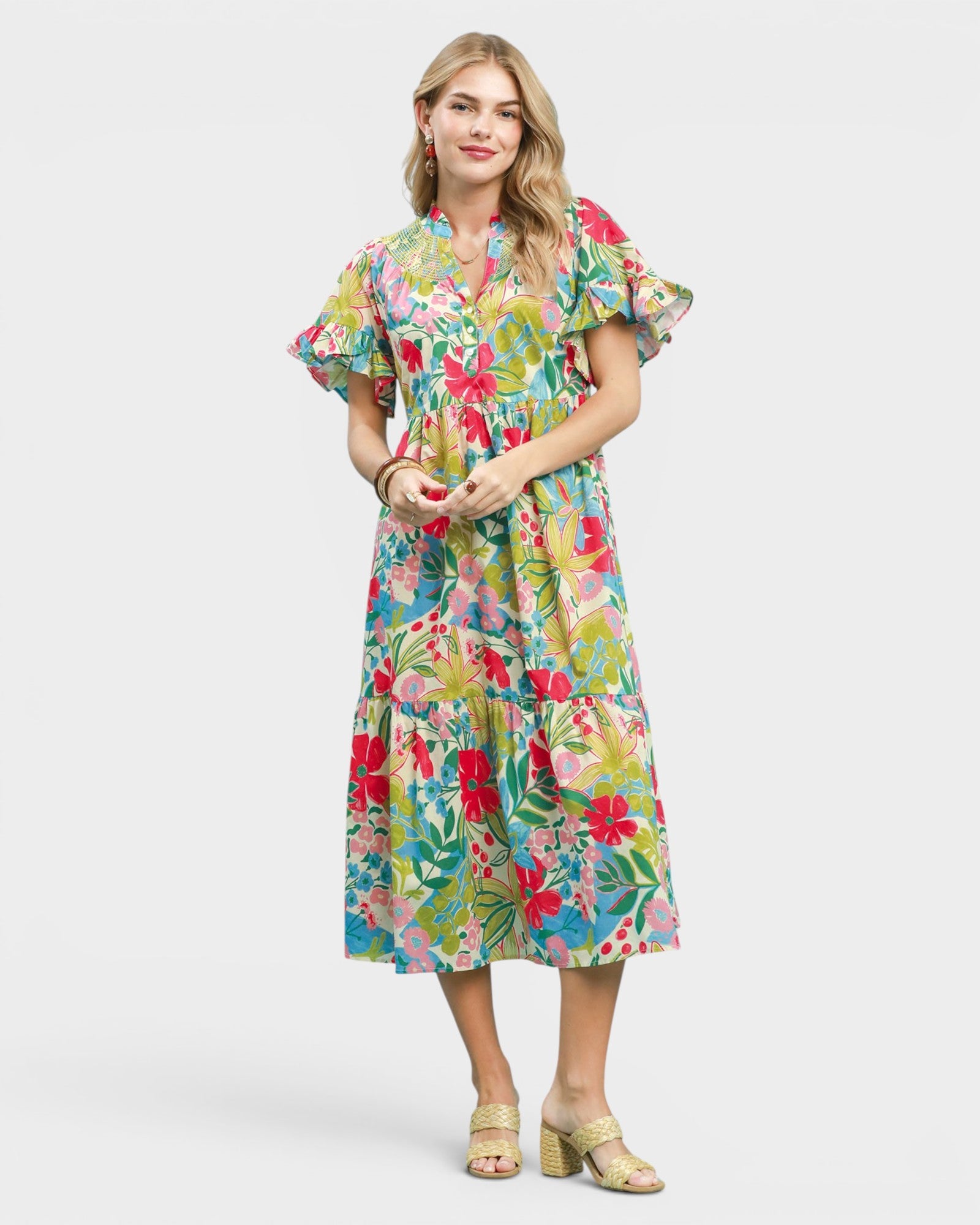 Woman wearing a colorful floral dress on a white background
