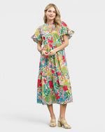 Woman wearing a colorful floral dress on a white background