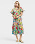 Woman wearing a colorful floral dress on a white background