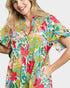 Woman wearing a colorful floral dress on a white background