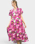 Woman wearing a pink floral dress on a white background