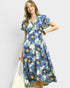 Woman wearing a blue floral dress on a white background