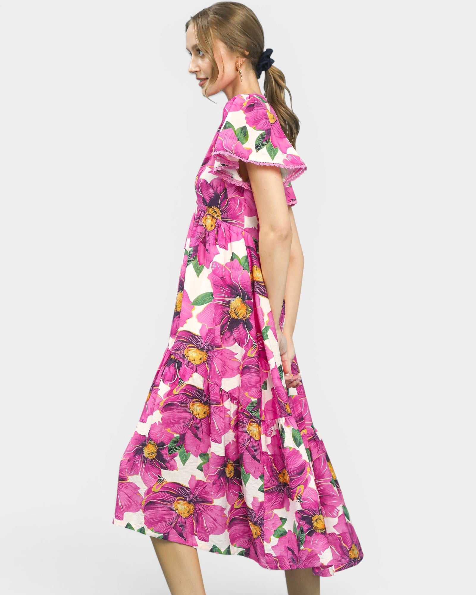 Woman wearing a pink floral dress on a white background
