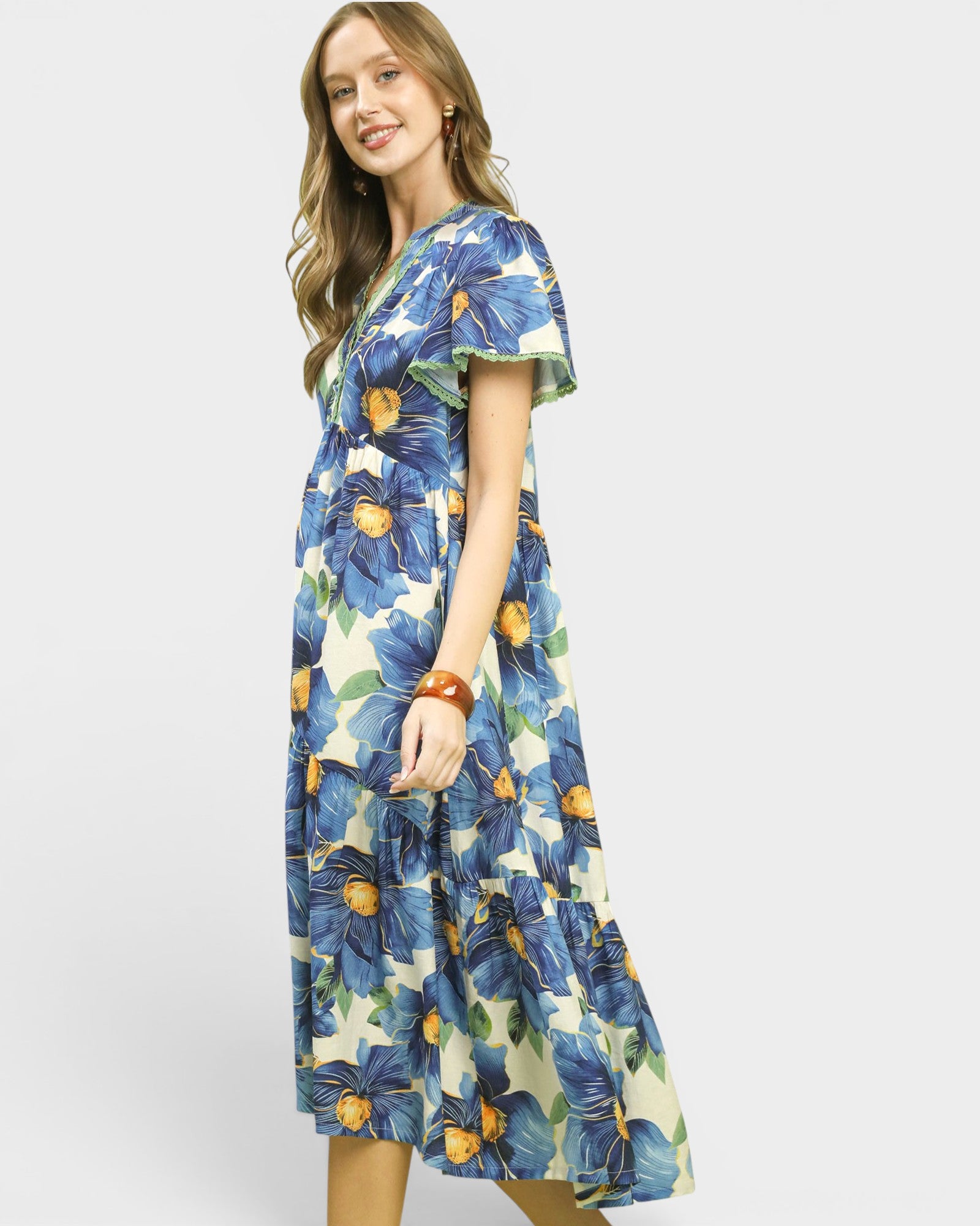 Woman wearing a floral dress with blue flowers on a white background