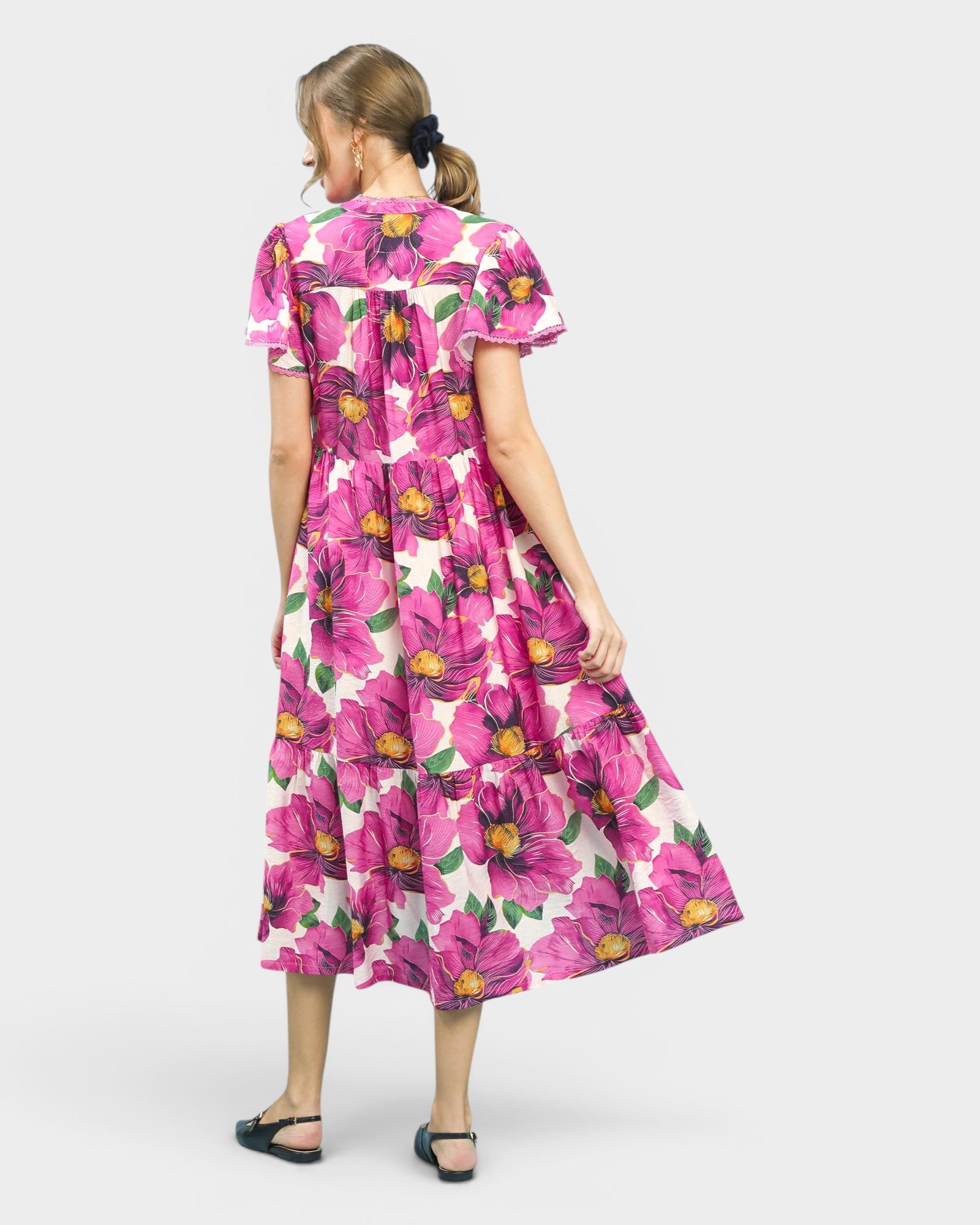 Woman wearing a pink floral dress on a white background