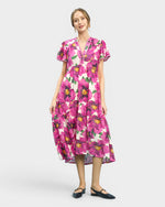 Woman wearing a pink floral dress on a white background