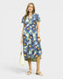 Woman wearing a blue floral dress on a white background