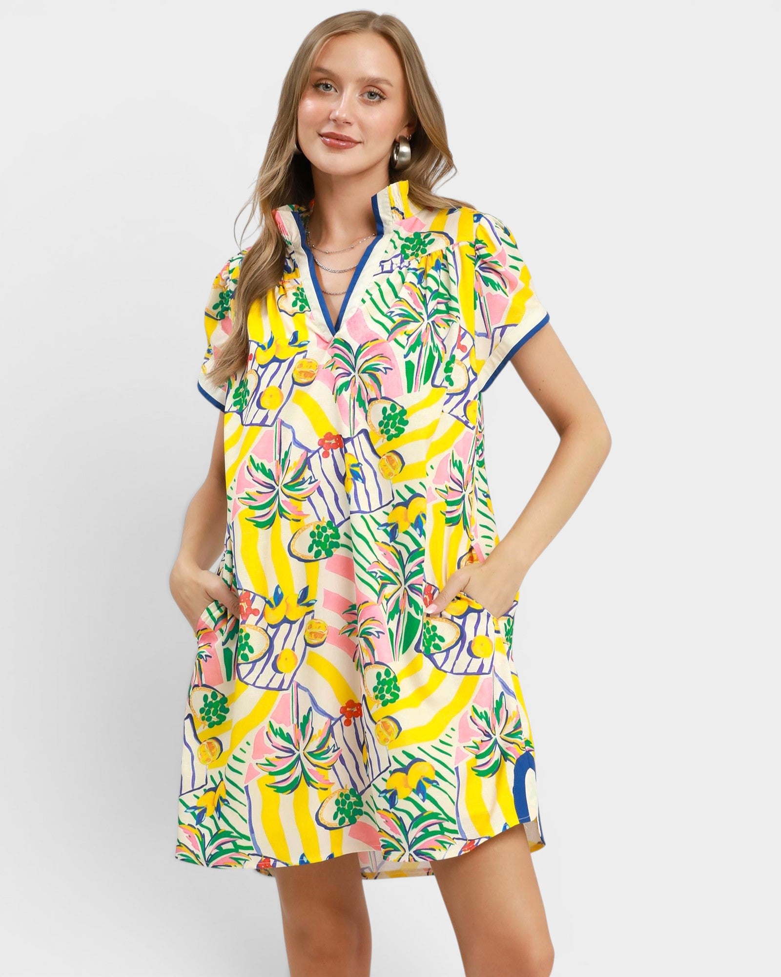 Woman wearing a colorful dress with a floral pattern on a white background