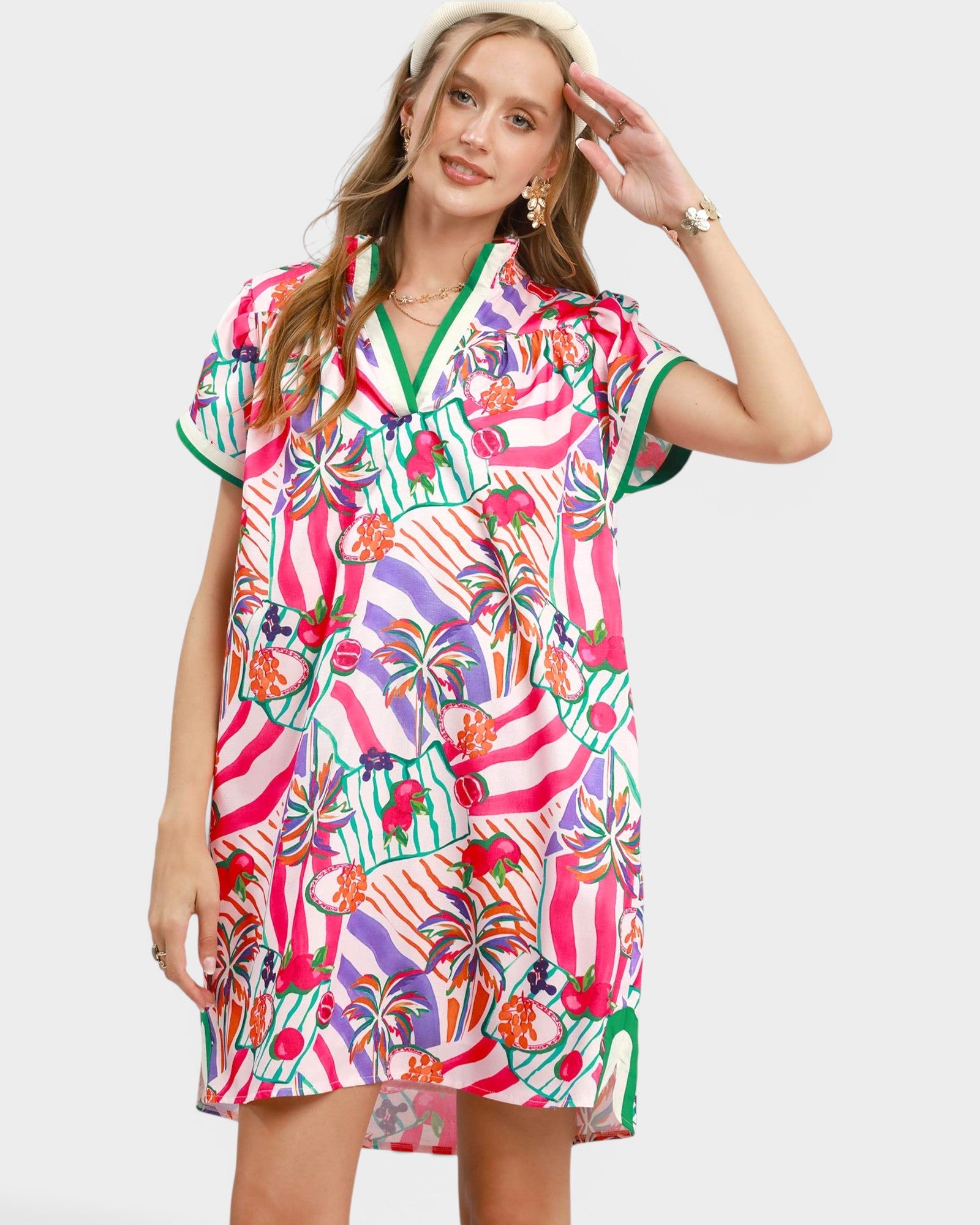Woman wearing a colorful patterned dress on a white background