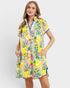 Woman wearing a colorful dress with a floral pattern on a white background