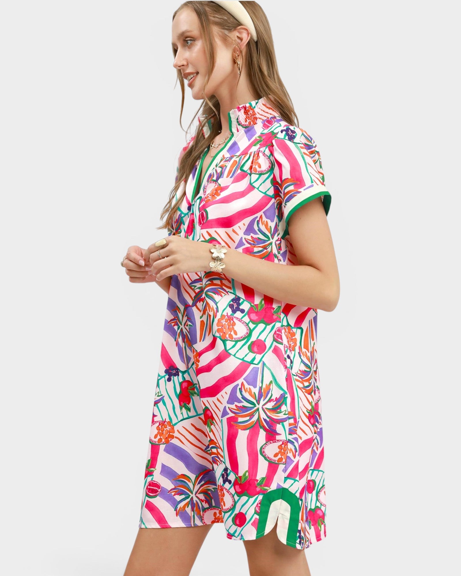 Woman wearing a colorful patterned dress on a white background