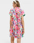 Woman wearing a colorful patterned dress on a white background