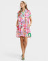 Woman wearing a colorful patterned dress on a white background